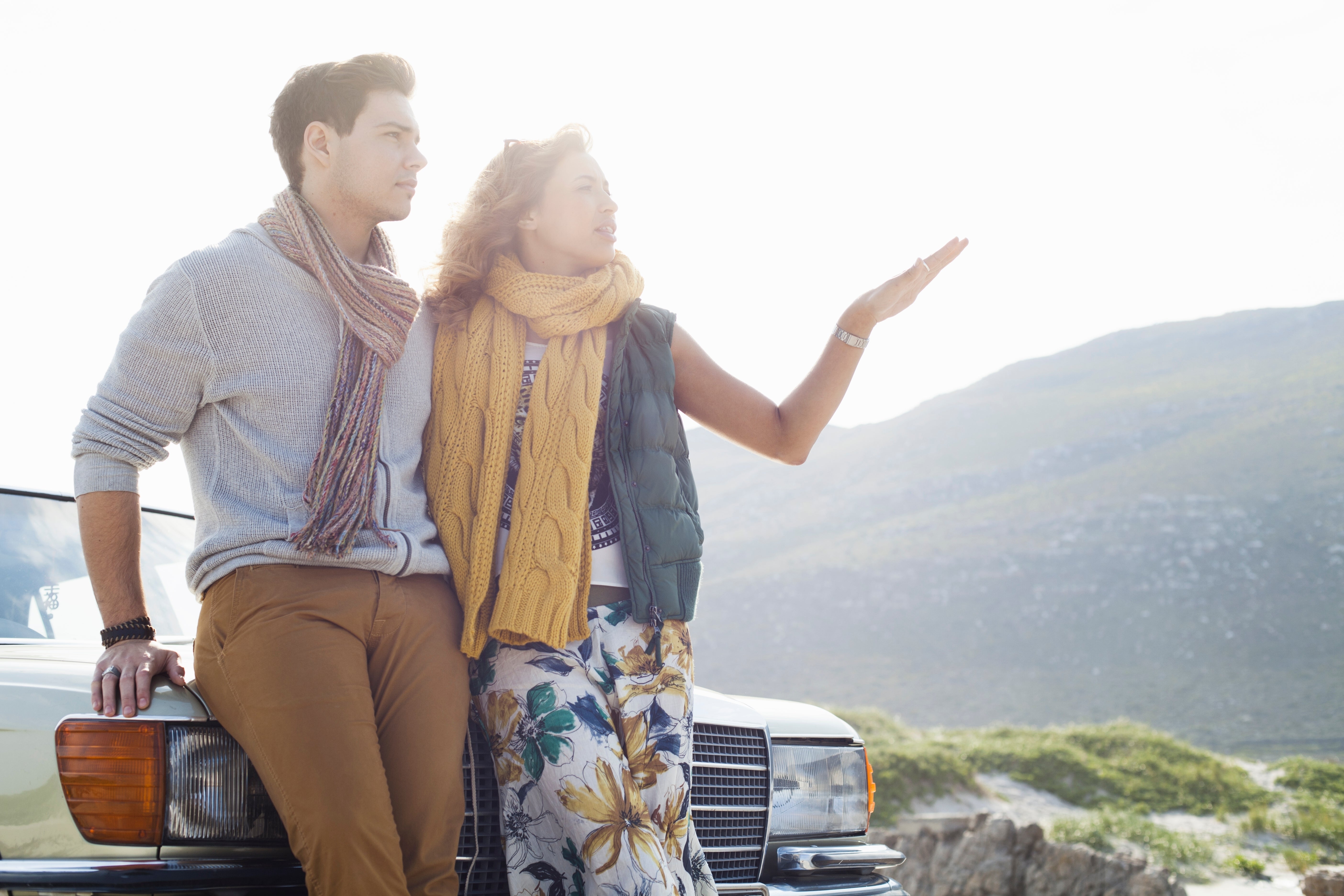 young-couple-leaning-against-car